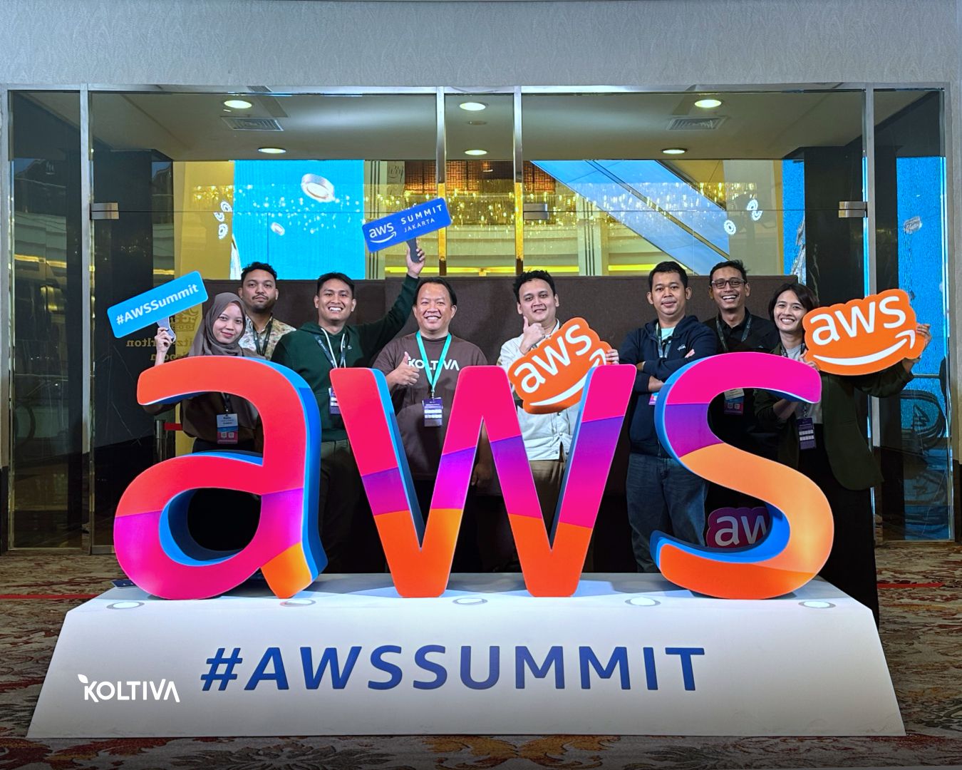 Visitors engaging with the AWS Summit showcase area.